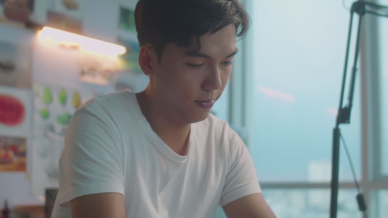 Asian Painter Drawing Picture with Wax Crayons