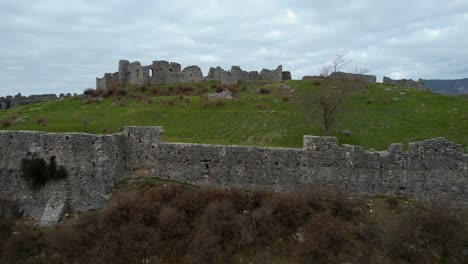 silent epic drama: lezha castle stands majestic on the hill with tall stone walls, echoing ancient battles on a dark day