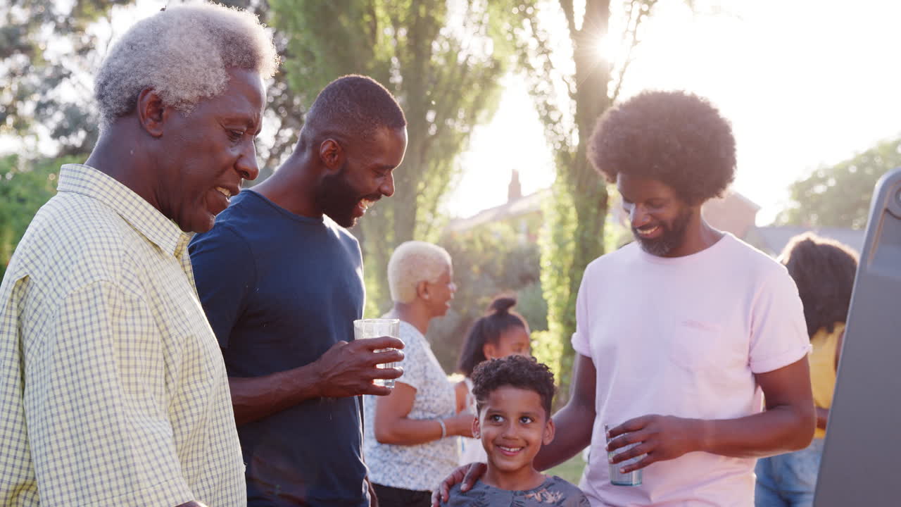 Family talking at a multi generation black family barbecue