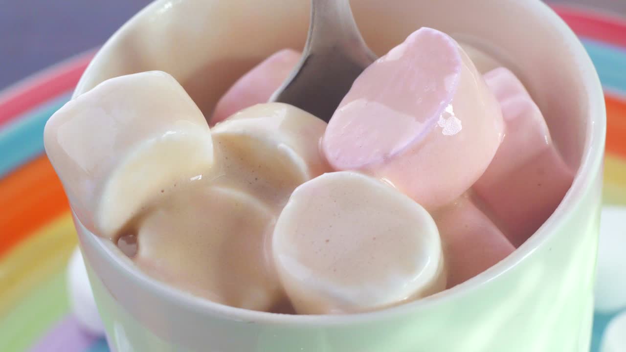 marshmallow in a Cup mix with spoon close up rotation