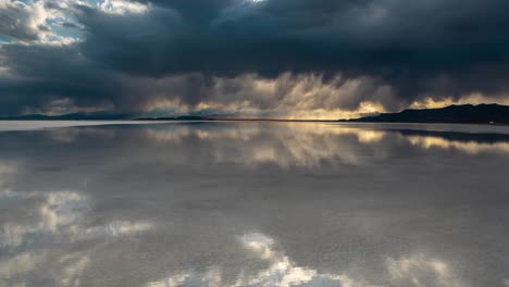 Timelapse, Dark Rainy Clouds and Sunset Sky Reflection on Calm Water in Bonneville Salt Flats, Utah USA