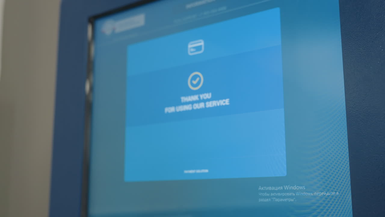 Close up payment machine screen showing digital interface with blue background displaying thank you for using service message, electronic checkout terminal display in operation
