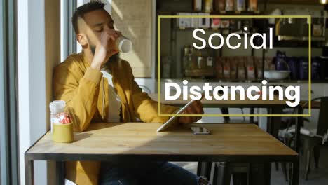 animation of a sign social distancing over caucasian man working and drinking in a coffee shop