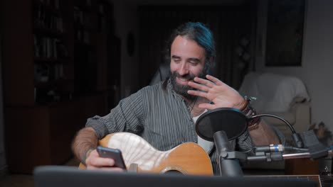 man playing guitar and streaming music online