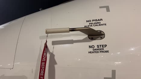 pilot putting the remove before flight label pitot cover for a medium size jet’s overnight