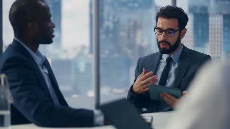 modern multi-ethnic office conference room meeting: diverse team of top managers, executives, share digital tablet computer talk. businesspeople discuss strategy, do analysis slow motion medium