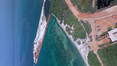 vista vertical de la construcción de puerto cabo rojo rodeado por el mar azul en pedernales, república dominicana