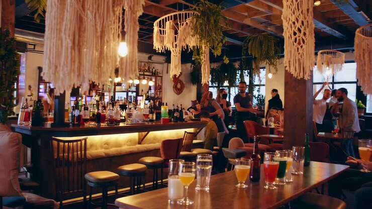 People socializing and enjoying drinks in a modern and lively bar or brewery interior