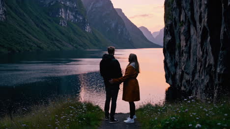 couple enjoying the sunset over a fjord