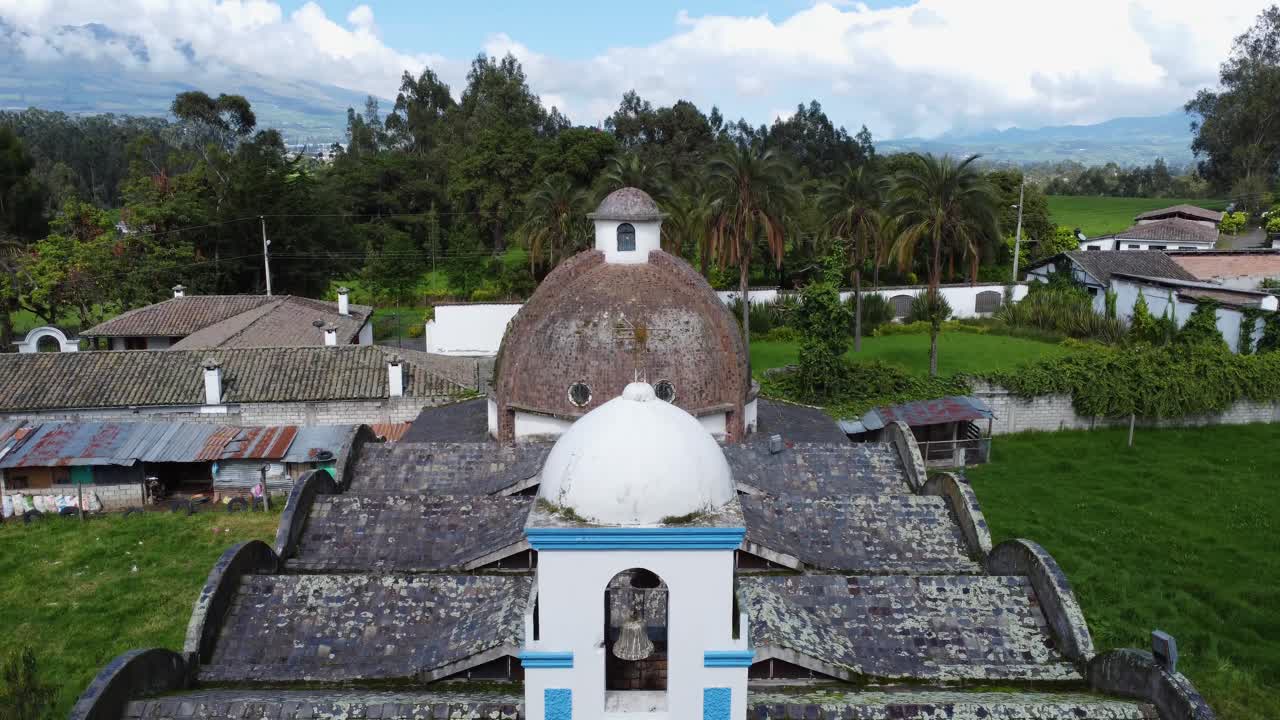 Elevation shot of the front of the Catholic church in Barrio G&uuml;itig amidst green nature