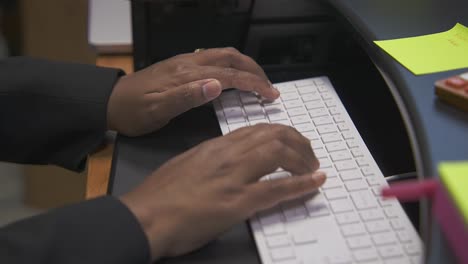 man fingers typing on a computer keyboard