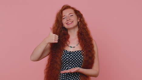 Redhead-woman-pointing-down,-saying-to-subscribe,-gesturing-ok,-like,-showing-place-for-information