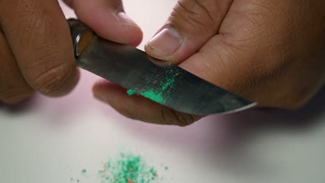 Footage-of-hands-slowly-sharpening-a-pencil-and-some-coloured-pencils-with-a-sharp-knife