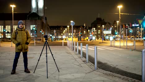 timelapse of night street with man shooting video. helsinki, finland