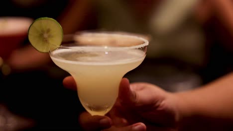 a cocktail is handed over in a bar