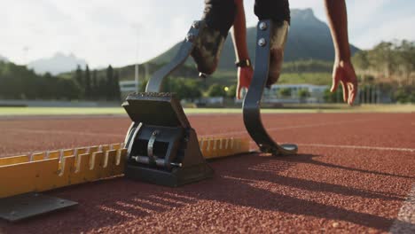 Disabled-mixed-race-man-with-prosthetic-legs-preparing-to-start-a-race-