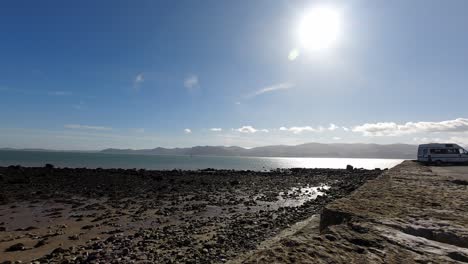 bright sunny wales uk mountain pebble coastline skyline timelapse boat sailing idyllic ocean