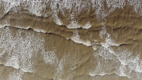top down view of the waves crashing and rising up as the sequence progresses