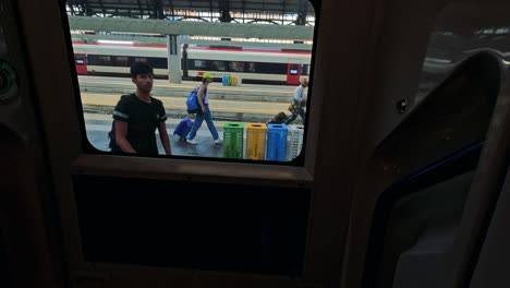 people waiting at a busy train station