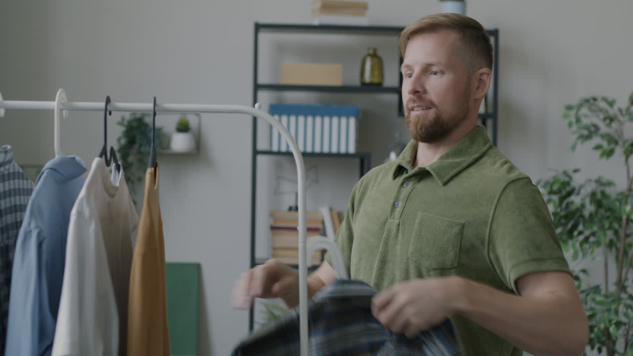 Man choosing clothes from a wardrobe
