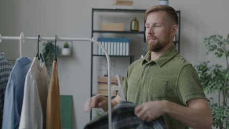 man choosing clothes from a wardrobe