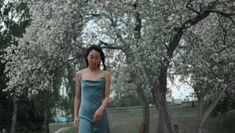woman in a blue dress in a spring park