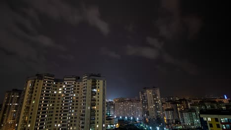 lightning over the city in the night sky during a thunderstorm. light from buildings