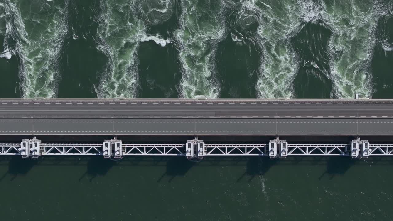 Top down of water flowing through the opened sluices of the Eastern Scheldt storm surge barrier in Zeeland, aerial