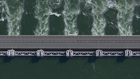 Top down of water flowing through the opened sluices of the Eastern Scheldt storm surge barrier in Zeeland, aerial
