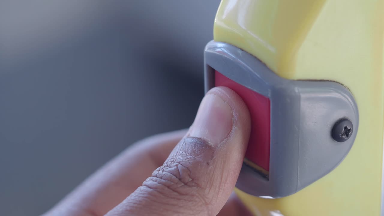 Person Pressing Emergency Button on Bus