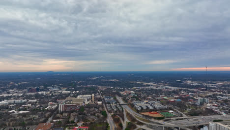 Aerial-birds-eye-view-of-Atlanta-cityscape,-Freeway,-Georgia-under-cloudy-sky,-USA