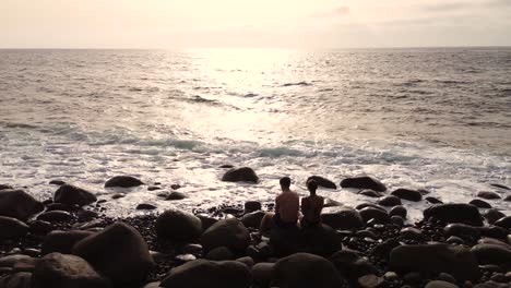 Idyllic-scene-of-two-people-at-unspoiled-virgin-beach-in-Gran-Canaria,-Spain-during-summer-time-on-vacations