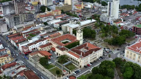 Rotating-aerial-drone-shot-of-the-European-downtown-of-the-tropical-coastal-capital-city-of-Joao-Pessoa,-Paraiba,-Brazil-with-old-skyscrapers-and-historic-buildings-during-golden-hour