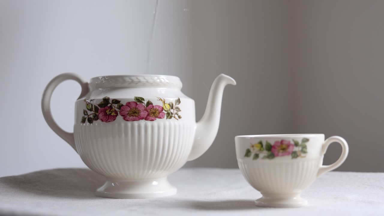 Pouring Hot Water into a Vintage Floral Teapot