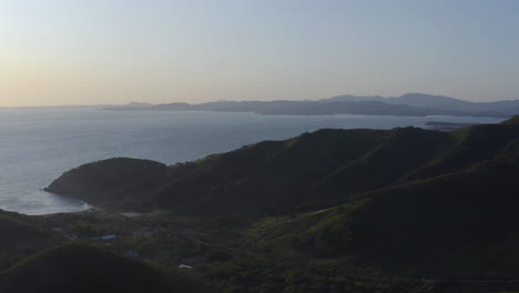 View-of-a-bay-surrounded-by-green-mountains-and-hills-on-a-sunset,-Russia,-Far-East