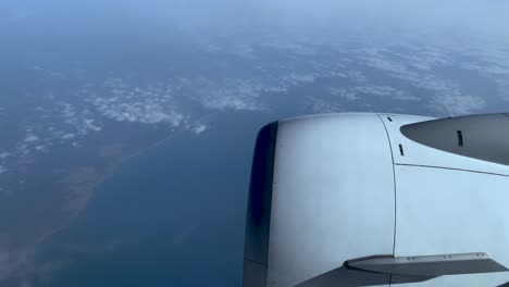 pov from airplane's window flying over biscayne bay in florida, united states