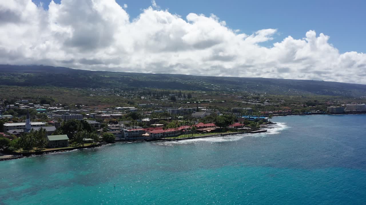 Wide panning aerial shot of the historic Kailua-Kona waterfront in Hawai'i