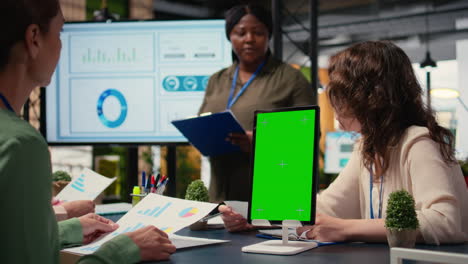 vertical video businesswomen attend meeting in the office with a mockup display