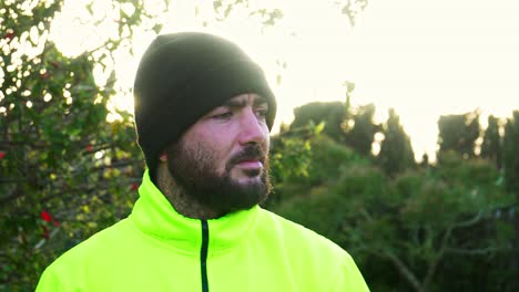 shot of a serious worker with a yellow reflective jacket playing with his hammer