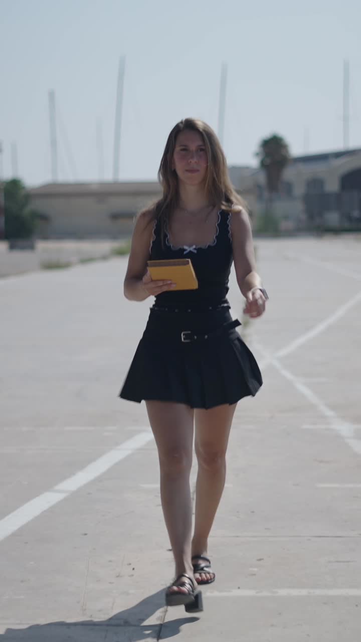 Woman in black dress walking outdoors