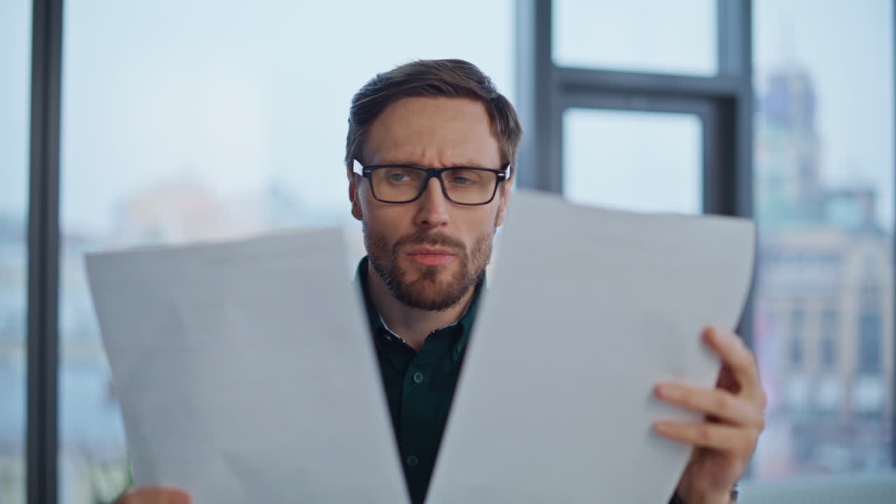 Serious startuper analyzing documents at workspace closeup. Stressed businessman