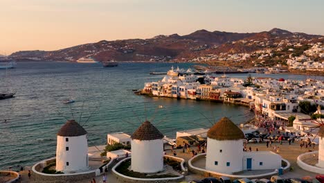 aerial sunset view of the famous windmills and mykonos town