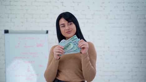 happy woman with money. portrait of cheerful young woman holding money banknotes