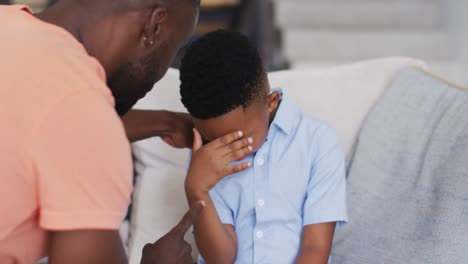 African-american-father-rebuking-his-son-on-a-couch