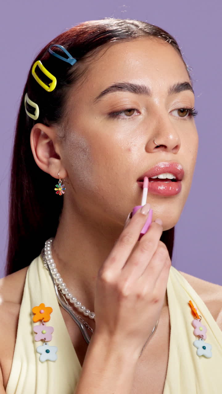 Woman applying lip gloss