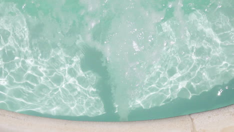 water bubbles bursting on the jacuzzi section of the pool, view from the top