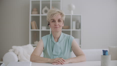 friendly-middle-aged-woman-is-looking-at-camera-and-greeting-waving-hand-and-smiling-videocalling-online-chat-and-distant-communication