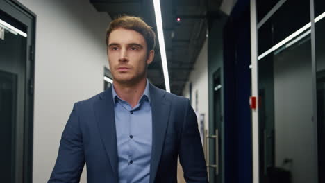 closeup employee going office corridor. businessman leaving conference room