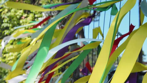 colorful ribbons tied to a fence