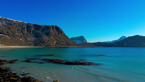 Pristine-mountains-seashore-and-a-seagull-enjoying-the-spring-sun-in-quite